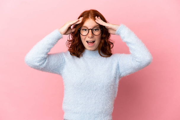 Teenager reddish woman isolated on pink background with surprise expression - Fotoğraf, Görsel