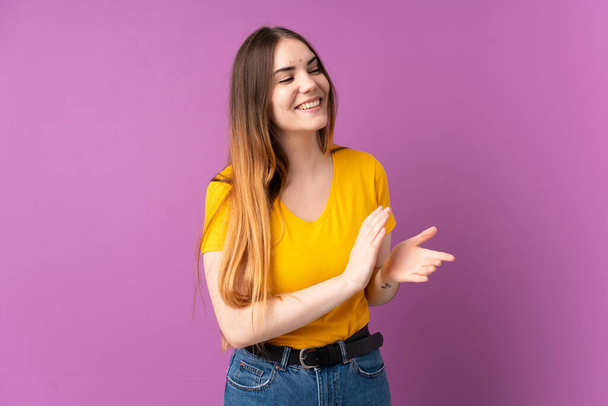 Young caucasian woman isolated on purple background applauding - Photo, Image