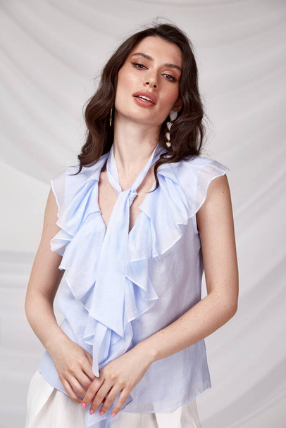 Beautiful sexy woman wear light blue color dress blouse accessory jewelry earrings summer collection cotton casual style tanned body brunette hair beautiful face makeup white background studio. - Foto, Imagem