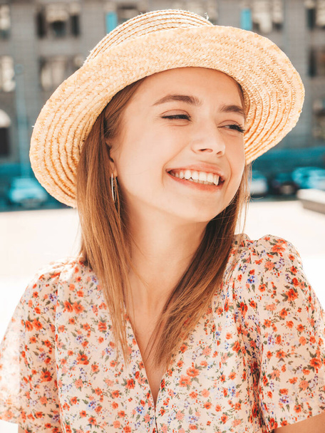Young beautiful smiling hipster woman in trendy summer dress. Sexy carefree woman posing on the street background in hat at sunset. Positive model laughing outdoors. Cheerful and happy - Foto, Imagen