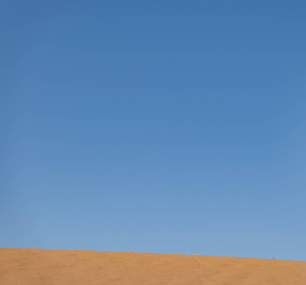 The clear blue sky over the sandy dunes in Sahara desert, Morocco - 写真・画像