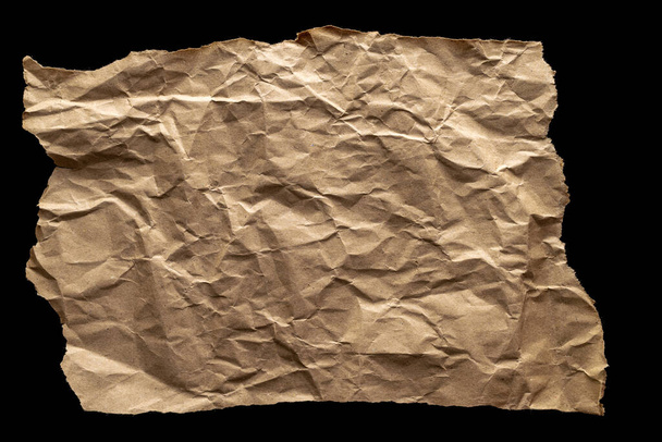 Torn craft. Kraft paper texture background. Old craft vintage cardboard isolated on black. For designs, decoration and nature background concept - Foto, afbeelding