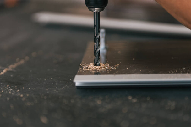 Drill hammered into a surface in a workshop - Φωτογραφία, εικόνα
