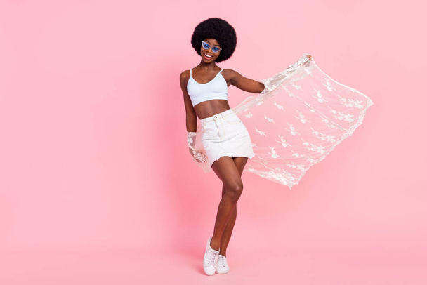 Full length body size photo stylish woman in sunglass wearing white cape shorts smiling isolated pastel pink color background - Φωτογραφία, εικόνα
