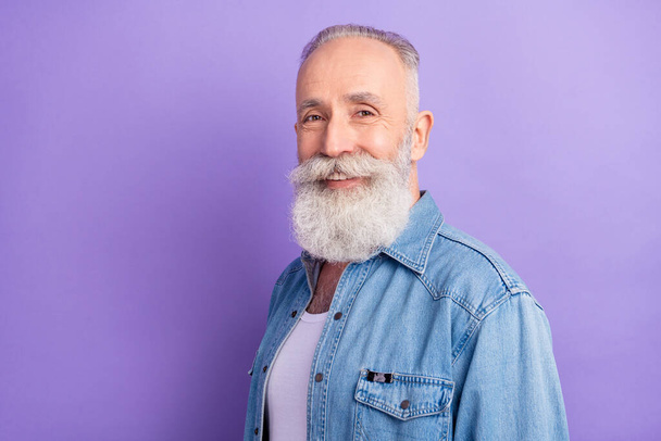 Photo of pretty cute mature man dressed denim outfit smiling empty space isolated purple color background - Фото, зображення
