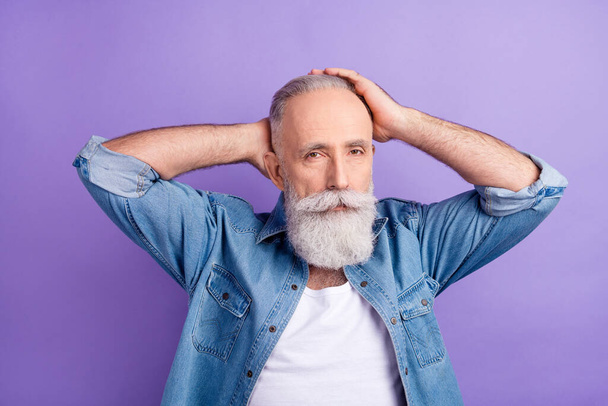 Photo of strong serious age gentleman wear jeans shirt arms head isolated violet color background - Fotó, kép