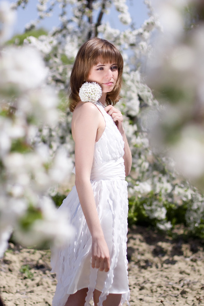 Beautiful girl with spring flower - Фото, зображення