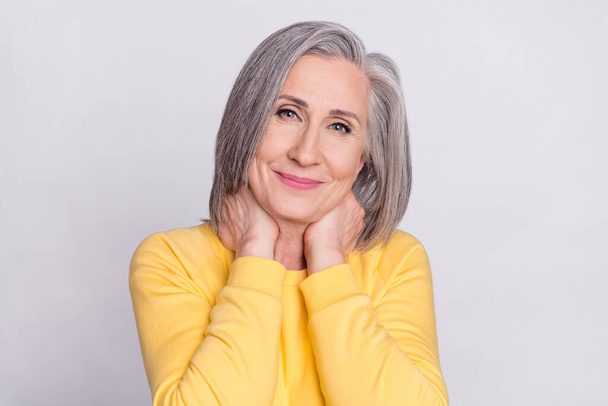 Photo of happy good mood pretty charming smiling mature woman wear yellow sweater isolated on grey color background - Foto, afbeelding