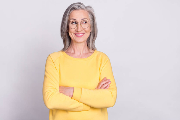 Photo of beautiful dreamy smiling confident businesswoman in glasses with folded arms isolated on grey color background - Фото, зображення
