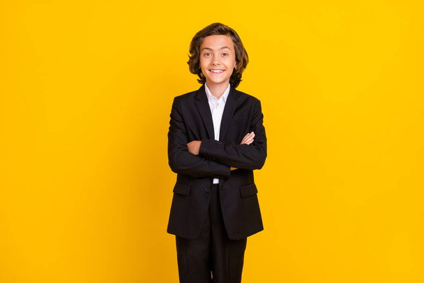 Photo of confident self-assured schoolboy toothy smile wear black uniform isolated yellow color background - Fotoğraf, Görsel