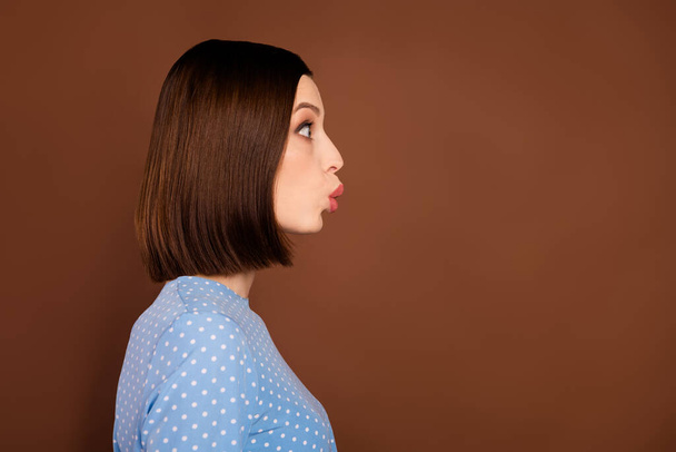 Profile photo of flirty bob hairdo millennial lady kiss empty space wear blue blouse isolated on brown color background - Fotoğraf, Görsel