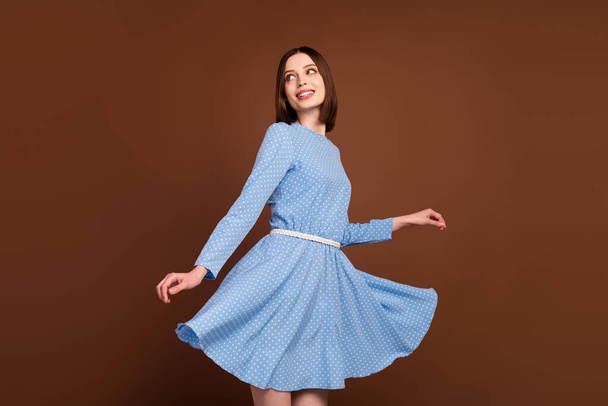 Photo of nice millennial lady dance wear blue dress isolated on brown color background - Foto, immagini