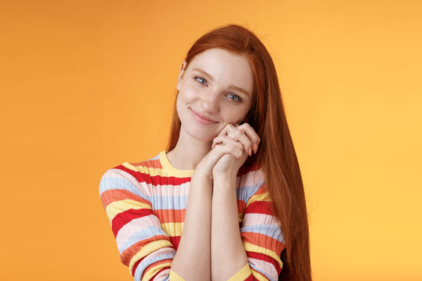 Dreamy sensual romantic young passionate redhead girlfriend melt heart feel sympathy joy receive sweet tender present lean palms smiling grateful gladly accept nice lovely gift, orange background - Foto, afbeelding