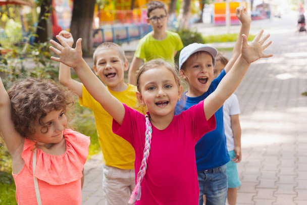 Cheerful emotional children having fun time outdoors - Φωτογραφία, εικόνα