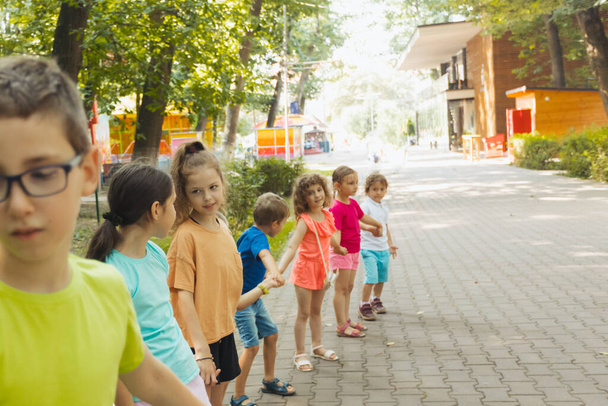 Lovely children playing outdoors at summer camp - Zdjęcie, obraz