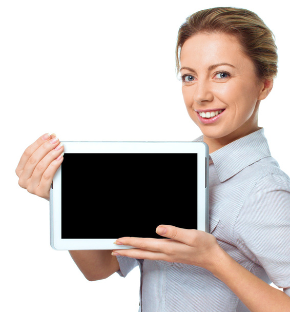 Young cheerful woman is showing blank tablet - Foto, Imagen