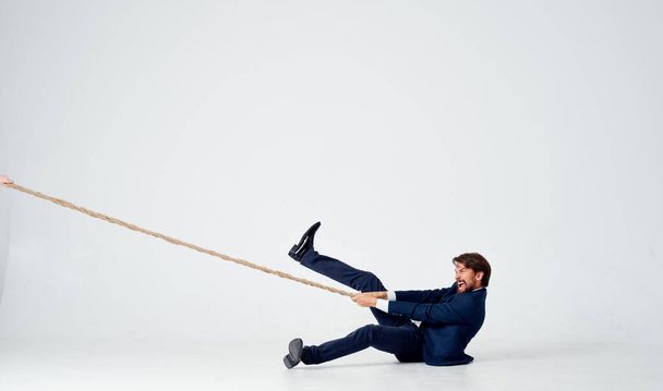 un homme en costume tirant une corde directeur de bureau travail d'équipe - Photo, image