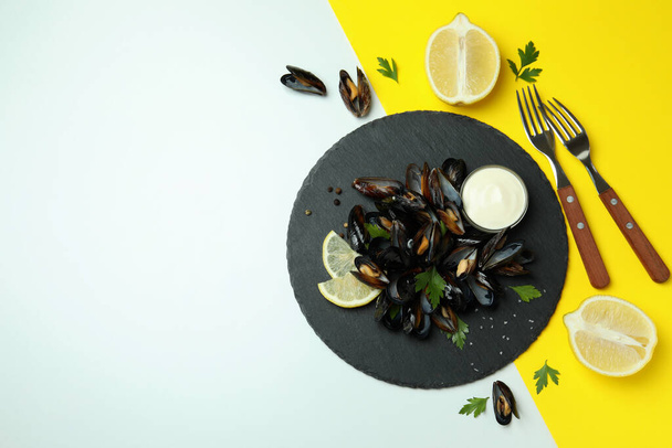 Concept of delicious food with mussels on two tone background - Photo, Image