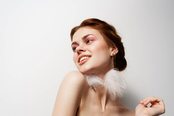 attractive women fluffy earrings nude shoulders cosmetics - Фото, изображение