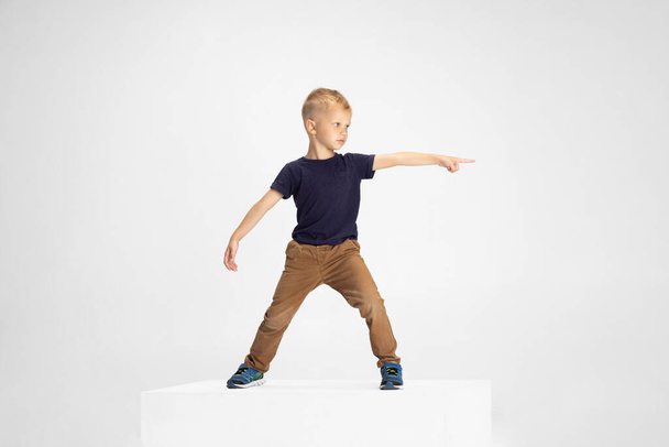 Portrait of cute Caucasian preschool boy isolated on white studio background. Copyspace for ad. Childhood, education, emotion concept - Foto, afbeelding