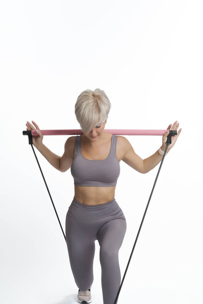 Beautiful sportive woman doing fitness with Slings. COPY SPACE. - Foto, immagini