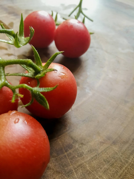 Cherry tomato on a wooden board - Photo, Image
