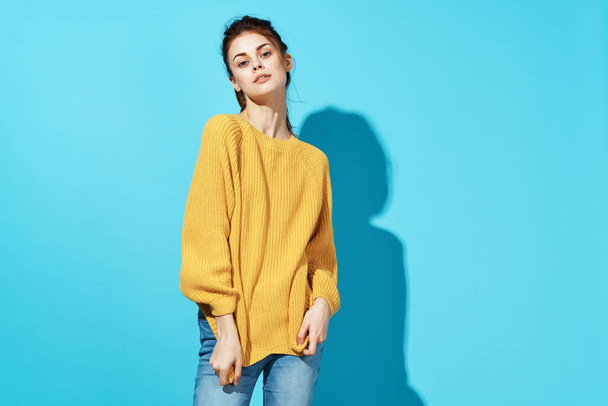 woman in yellow sweater posing fashion lifestyle studio - Fotó, kép