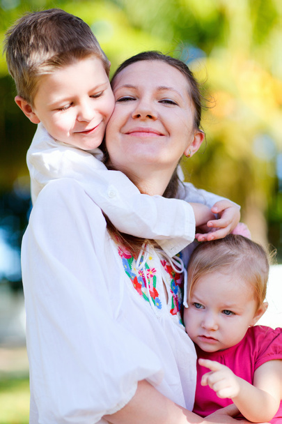 Summer family portrait of happy young mother with her two kids - Foto, imagen