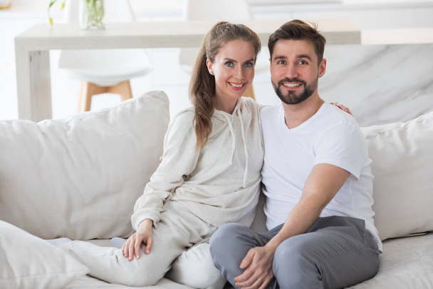 Couple relaxing in living room and smiling - Foto, immagini