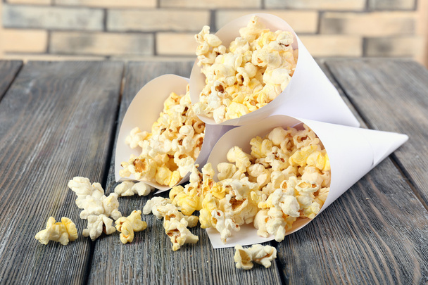 Popcorn on wooden table - Photo, Image