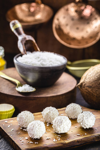coconut balls, coconut candy with ingredients in the background, rustic and healthy cuisine - Photo, Image