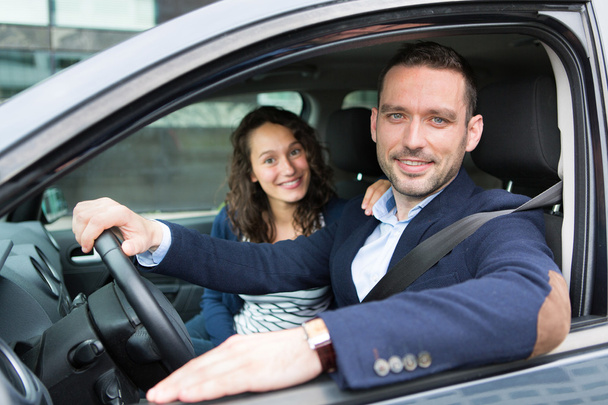 Young business man couple in their brand new car  - Photo, Image