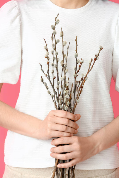 Woman with willow branches on color background - Photo, Image