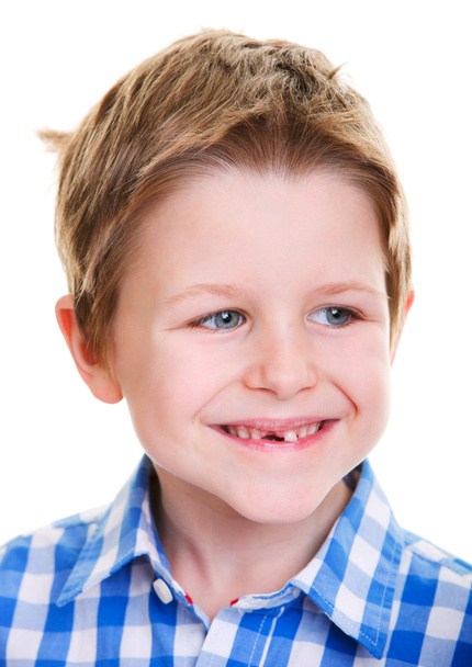 Studio portrait of cute 6 years old boy showing his missing tooth - Valokuva, kuva