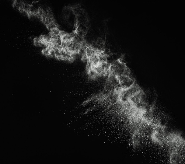 White powder exploding isolated on black - Photo, Image
