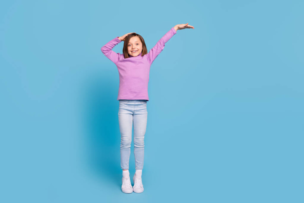 Full length body size little girl smiling showing growth cheerful isolated pastel blue color background - Fotoğraf, Görsel
