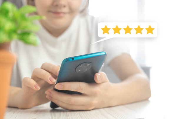 Customer service evaluation concept background, woman hand with mobile phone and feedback icon, review the service  - Photo, Image