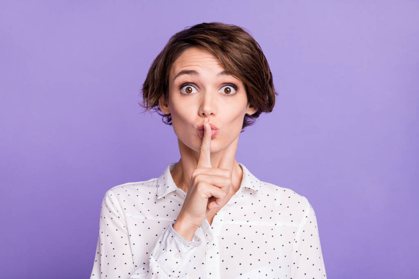 Photo of charming young lady finger covering mouth lips do not tell isolated on violet color background - Foto, Imagem