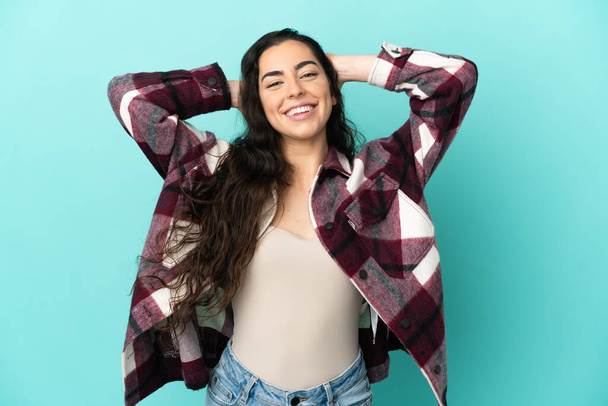 Young caucasian woman isolated on blue background laughing - Photo, image