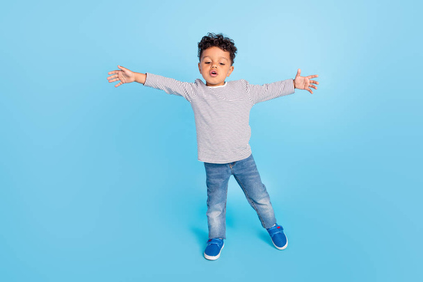 Full length body size view of nice funny boy showing wide hug isolated over bright blue color background - Foto, Imagen