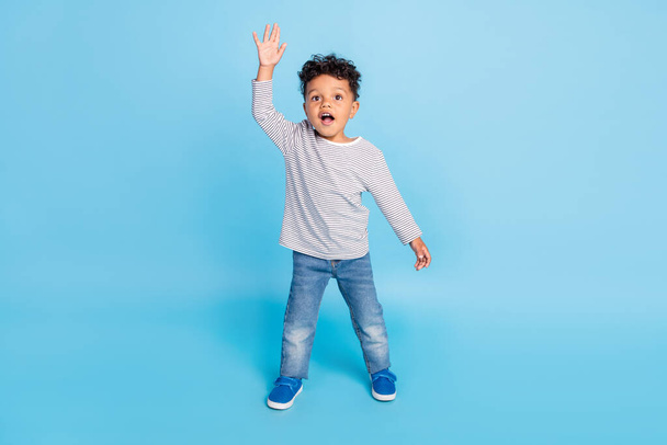 Full length body size view of attractive friendly cheerful boy waving hi isolated over bright blue color background - Foto, immagini