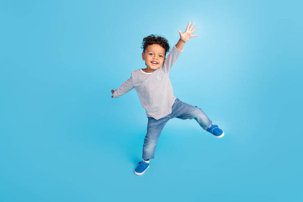 Full length body size view of attractive cheerful carefree boy dancing good mood isolated over bright blue color background - Fotografie, Obrázek