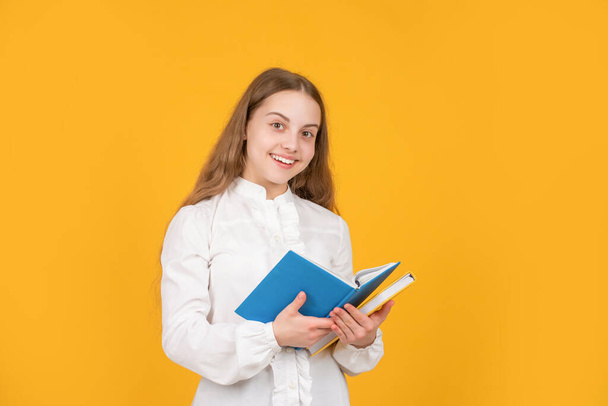 smiling teenager student. education in high school. schoolgirl with copybook. - 写真・画像