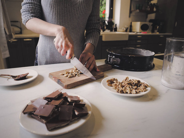 Woman cooking a chocolate cake in kitchen  - Photo, Image