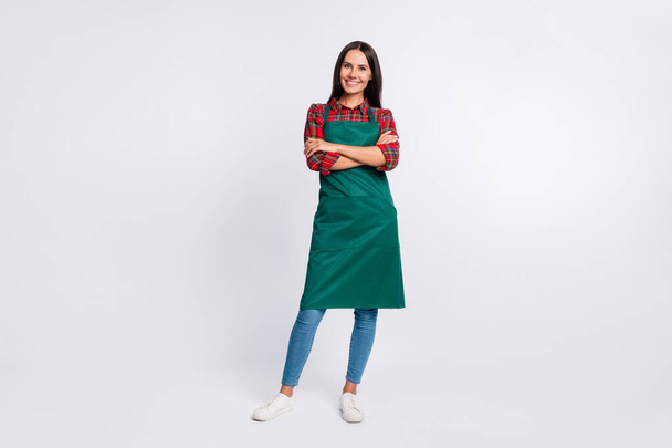 Full length photo of charming young lady hands folded wear green apron barista isolated on grey color background - Fotó, kép