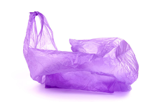 Transparent purple plastic bag with handles isolated over white background - Foto, afbeelding