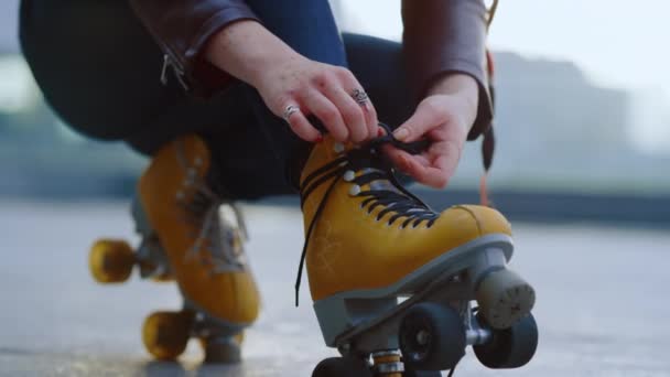 Unbekannter Rollschuhfahrer bereitet sich auf Training vor Frau bindet Schnürsenkel an Skates. - Filmmaterial, Video