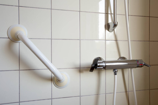 Shower and handrail,grab bar for elderly people at the bathroom in hospital or retirement home , safty and medical concept close up - Photo, Image