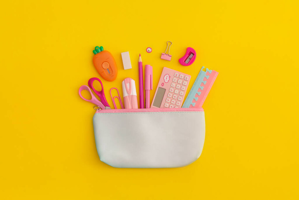 Pencil case with school stationery on a yellow background. Top view. Flat lay. Back to school concept. - Photo, Image