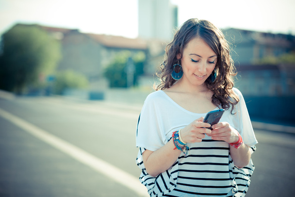 young beautiful brunette woman with smart phone - Fotografie, Obrázek